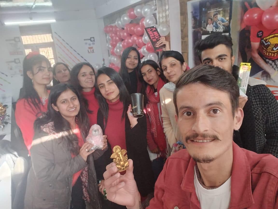 Team celebration with balloons at HighlandConnect office